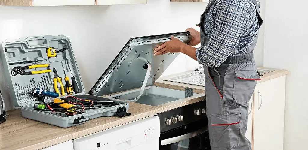 Handyman repairing a cooktop and checking wiring connections in Cape Coral, FL