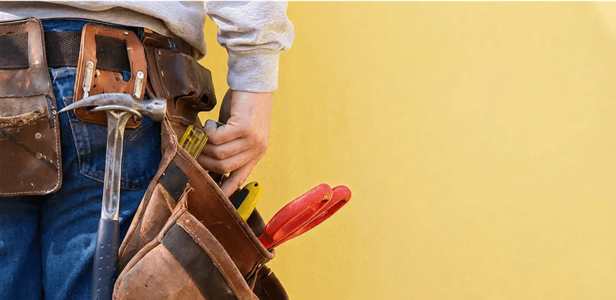 Handyman with tool belt ready for home repairs and maintenance in Cape Coral, FL