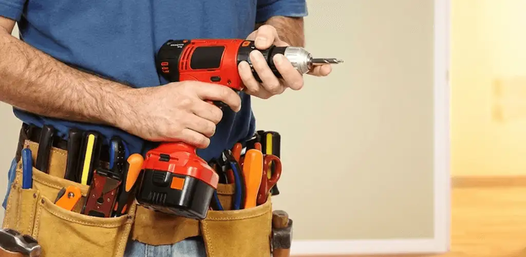 Handyman holding a power drill for home repairs and installations in Cape Coral, FL