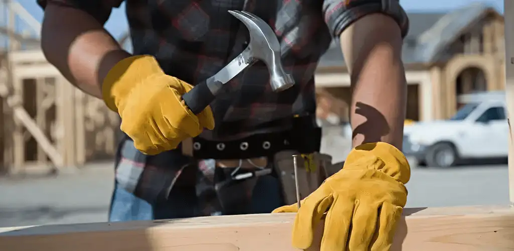 Handyman fixing wood trim with a hammer for home repairs in Cape Coral, FL