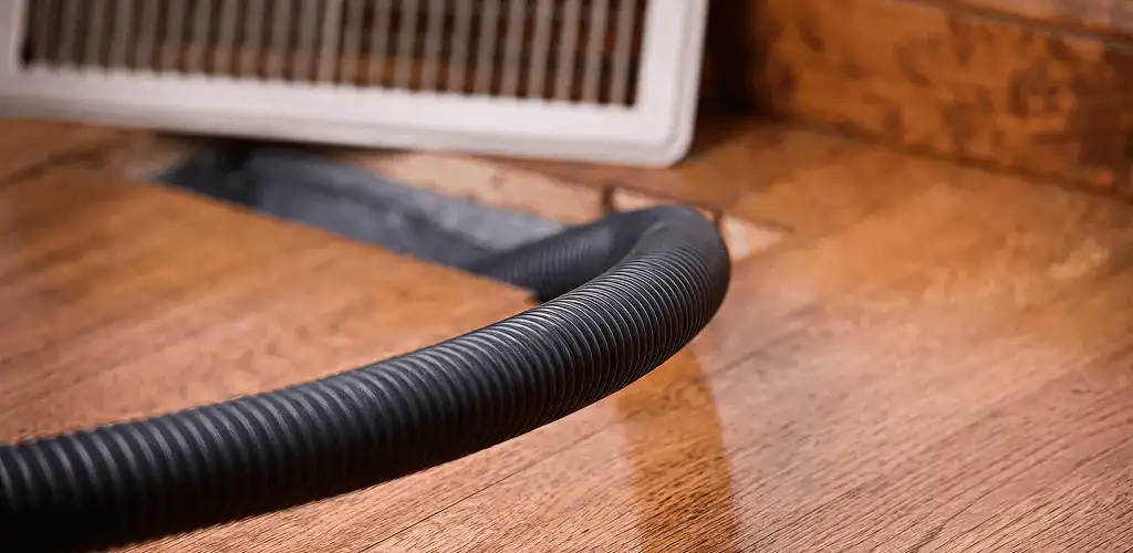 Air duct cleaning hose inserted into a floor vent for ductwork cleaning in Cape Coral, FL