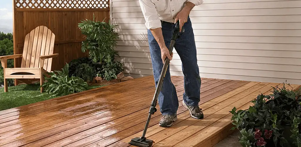 Deck staining service applying stain to a backyard wood deck in Cape Coral, FL